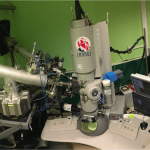 Overview of the Transmission Electron Microscope with its two ion beam connections seen on the left (© C. Baumier)